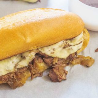 Slow-Cooker French Dip Sandwich. Beef roast and onions slow cook in seasoned stock until tender. Serve on a toasted cheese roll with a side of broth for dipping.