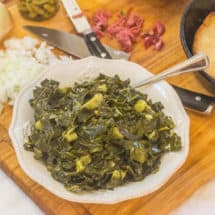 Southern-Style Collard Greens with Ham Hocks. Shredded collards cooked in a rich ham hock stock with touch of honey. Served with fresh sweet onions and hot pepper sauce along with a side of hot water cornbread.