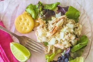 West Indies Salad. Fresh crabmeat marinates overnight with sweet onion and vinaigrette. Serve with lemon or lime atop fresh salad greens.