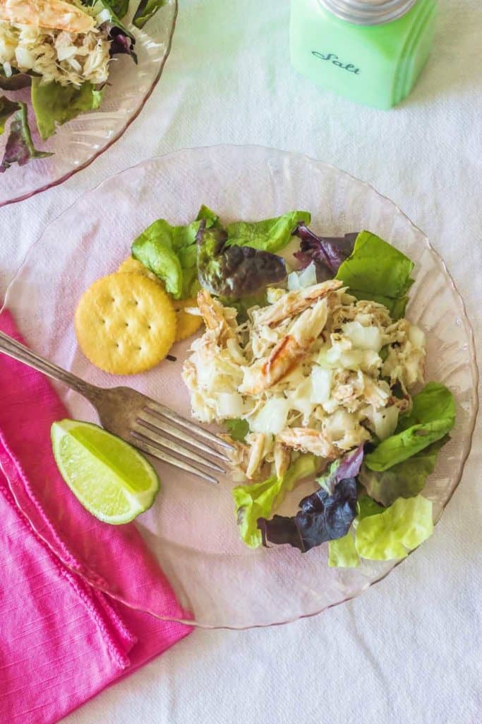 West Indies Salad. Fresh crabmeat marinates overnight with sweet onion and vinaigrette. Serve with lemon or lime atop fresh salad greens. 