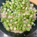 onions and okra in a skillet