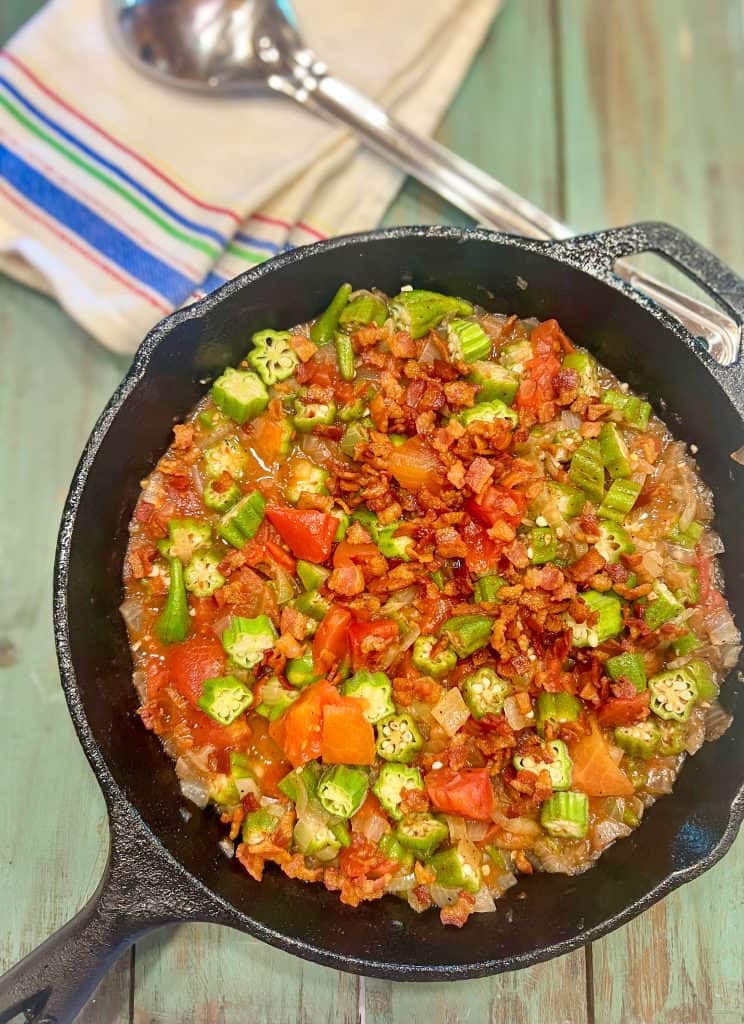okra and tomatoes in an iron skillet