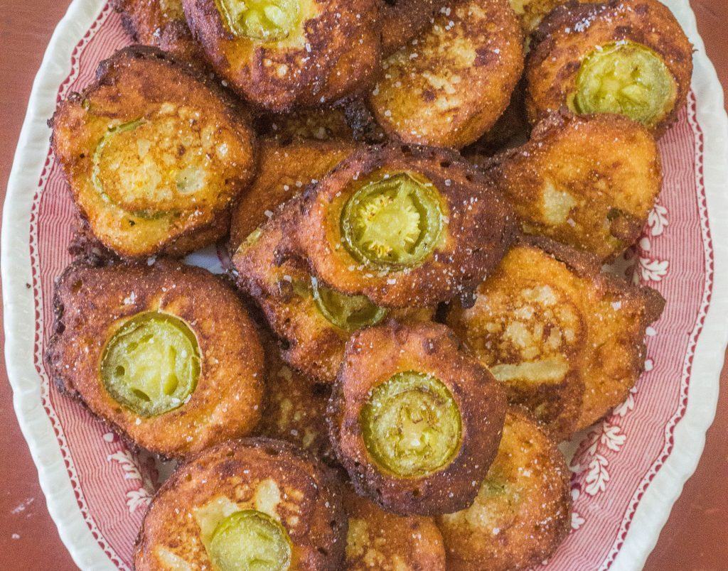 Jalapeno Cheddar Cornbread Fritters. Pickled jalapeno peppers, cheddar cheese and sour cream folded into a cornbread base and fried as a fritter.