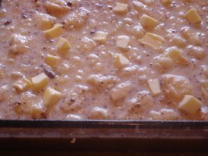 Biscuit pudding mixture in oven baking.