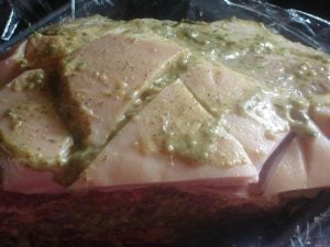 Fresh ham pork shoulder in slow cooker.