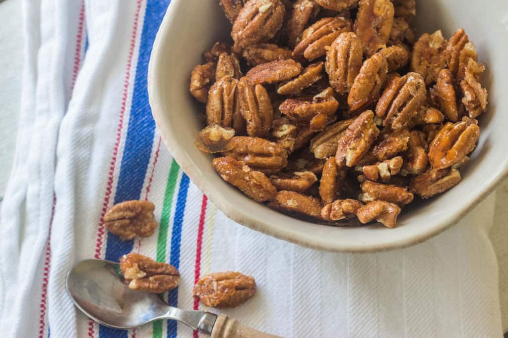 Spiced Pecans. Coat pecans with a spicy syrup and roast in the oven. 