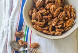 Spiced Pecans. Coat pecans with a spicy syrup and roast in the oven.