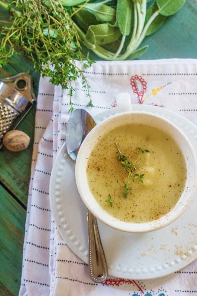 Creamy Turnip Potato Soup is turnip roots, Yukon Gold potatoes, sweet onions, garlic, and herbs stewed in butter with added chicken stock and served with a light grating of fresh nutmeg.