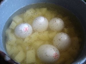 Boiling eggs and potatoes.