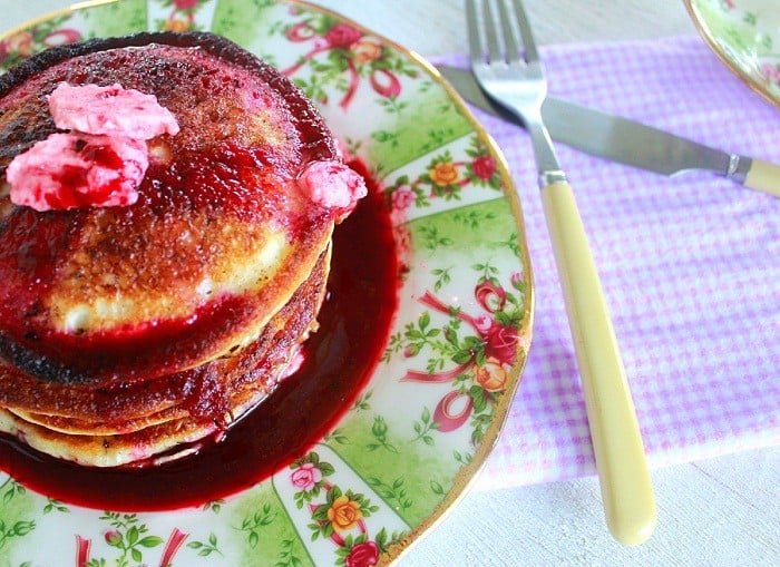 pancakes on a plate with blackberry syrup and blackberry butter