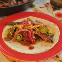 Beef Fajitas. Marinated skirt steak, onions and peppers. Served on flour tortillas with toppings.