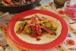 Beef Fajitas. Marinated skirt steak, onions and peppers. Served on flour tortillas with toppings.