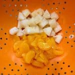 pineapple and mandarin oranges in a colander