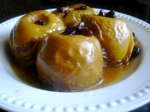 Girl Scout Baked Apples. Apples stuffed with butter, cinnamon, raisins and sugar and  cooked in a slow cooker.