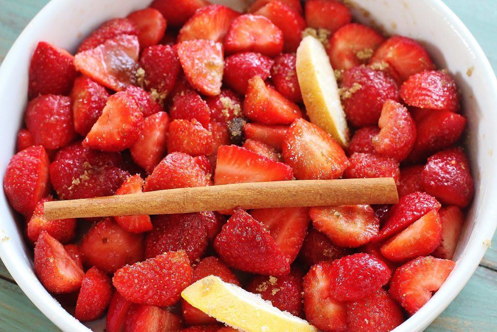 Roasted strawberries. Fresh strawberries, brown sugar, cinnamon stick, lemon slices and a pinch of salt. Ready for roasting.