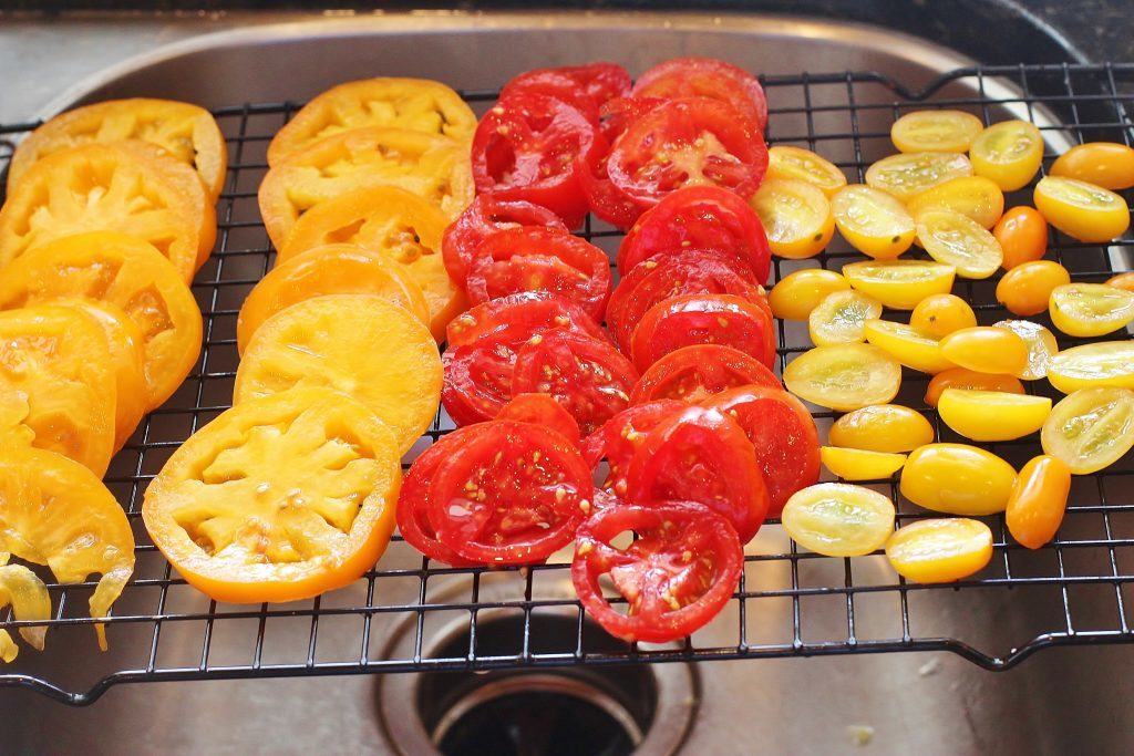 Sprinkle tomatoes with salt and let them drain for at least one hour before using them.  