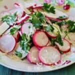 Easter Egg Radish Salad. Sliced Easter Egg Radishes, Parmesan cheese, parsley and a creamy dressing make this colorful dish to use as a salad or a garnish.