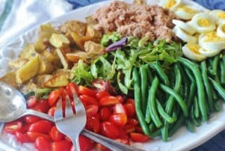 Tuna Nicoise Salad. A hearty salad made with tuna, roasted potatoes, green beans, boiled eggs and fresh tomatoes.