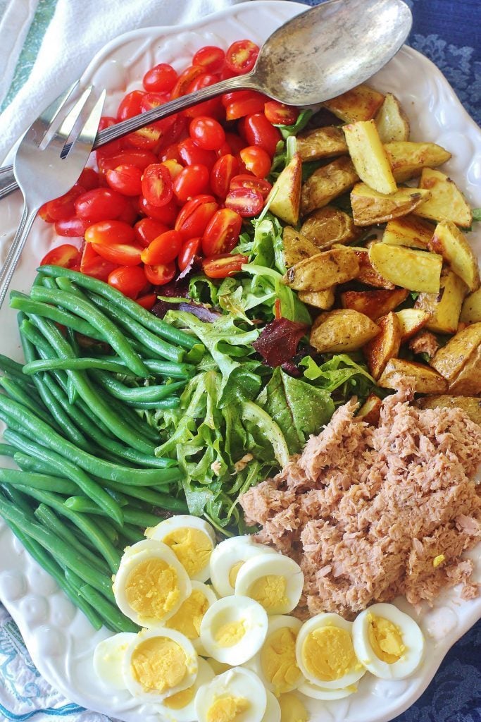 Tuna Nicoise Salad. A hearty salad made with tuna, roasted potatoes, green beans, boiled eggs and fresh tomatoes.