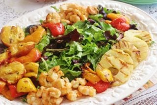 Grilled Shrimp and Fruit Salad. Wild caught Gulf shrimp, sweet bell peppers, nectarines and pineapple marinated in Creamy Honey Lime Dressing and grilled. Served atop a bed of spring lettuce mix.