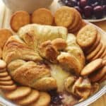 Baked Brie with Raspberry Jam. Brie topped with raspberry jam and baked in a puff pastry. Serve with crackers.