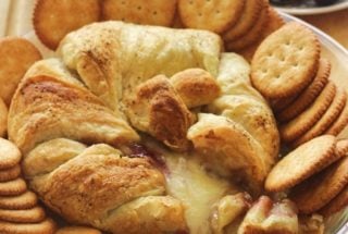Baked Brie with Raspberry Jam. Brie topped with raspberry jam and baked in a puff pastry. Serve with crackers.