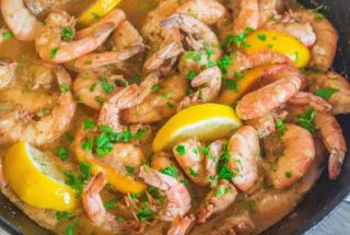 shrimp in a cast iron skillet in buttery broth