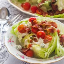 Wedge Salad with Buttermilk Blue Cheese Dressing. Iceberg lettuce, homemade buttermilk blue cheese salad dressing, tomatoes and bacon.