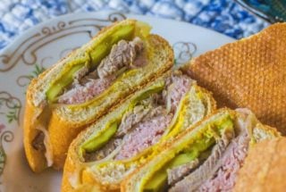 Authentic Cuban Sandwich Ybor City-style. Cuban bread, mustard, dill pickles, ham, pork and Swiss cheese create this iconic sandwich.