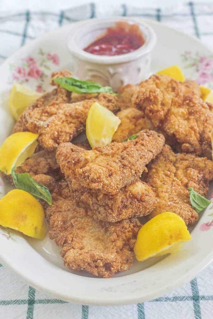 Southern Fried Catfish with lemons and dipping sauce.