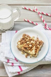 Gingerbread Magic Cookie Bars is a variation of the original Magic Cookie Bars from Eagle Brand Sweetened Condensed Milk.  Gingersnap cookies and orange juice form a  crust that's reminiscent of gingerbread cake. The layers of coconut, white chocolate, cinnamon chips, and toffee chips add a delightful spin to the classic recipe.