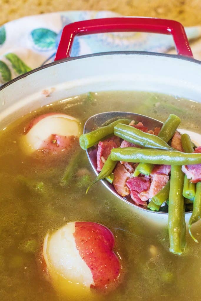 Southern-Style Green Beans, potatoes and ham in cooking pot. 