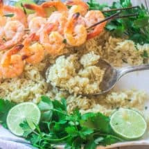 skewered shrimp with cilantro lime rice on a platter