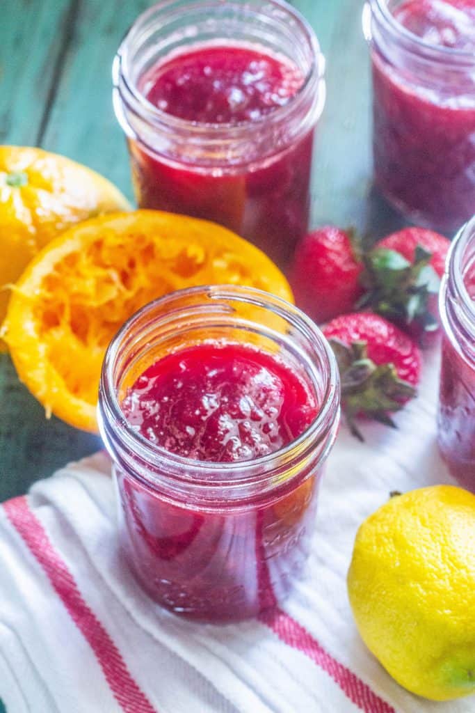 Strawberry Sangria Refrigerator Jam in jars on table.