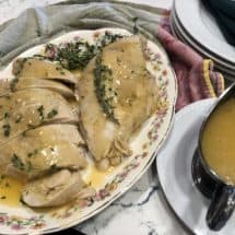 Turkey breast with gravy on a platter