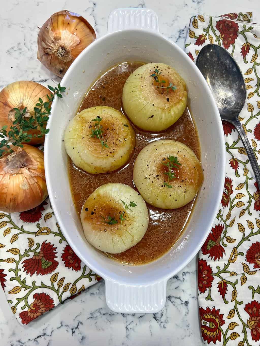 Baked Sweet Onions will remind you of French Onion Soup. Whole onions are peeled, topped with beef bullion,  butter, brandy, Worcestershire sauce, and fresh thyme and wrapped individually in foil packets.