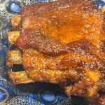 sheet pan maple bourbon barbecue spare ribs on a serving platter
