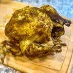 cooked whole chicken on a cutting board