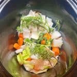 vegetables and herbs in a slow cooker